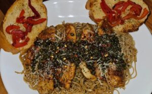 Piccata di pollo piccante su capelli d'angelo all'aglio fermentato